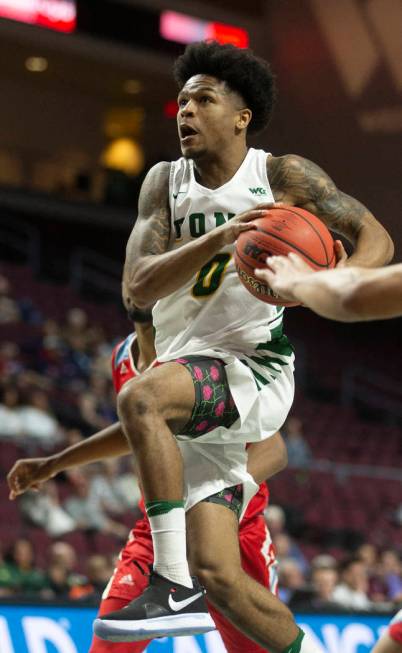 San Francisco Dons guard Khalil Shabazz (0) drives past Loyola Marymount Lions forward Jonathan ...