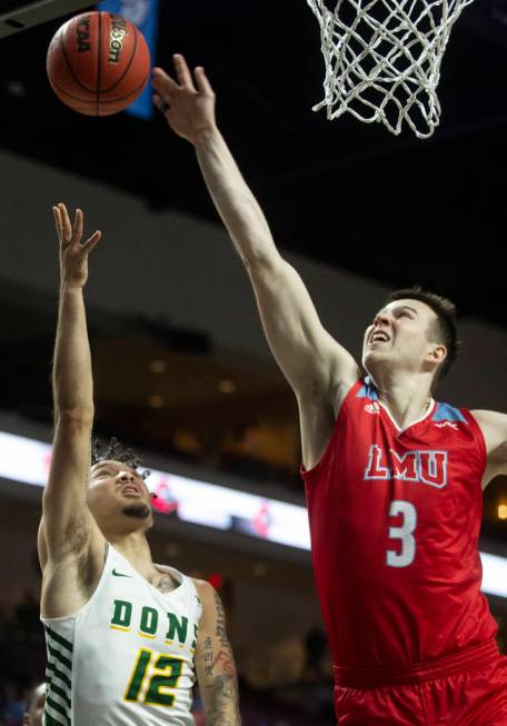 San Francisco Dons guard Trevante Anderson (12) drives baseline past Loyola Marymount Lions for ...