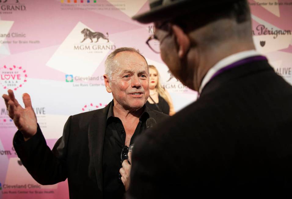 Wolfgang Puck talks with the media on the red carpet during the 24th Annual Power of Love Gala ...