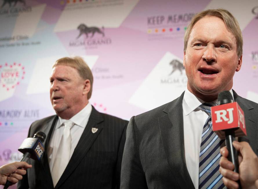 Raiders head coach John Gruden, right, and Raiders owner Mark Davis talk with the media on the ...