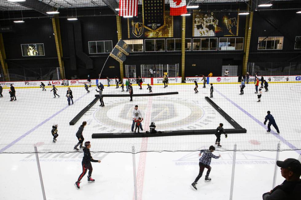 Golden Knights fans skate on the ice at City National Arena during a watch party for an away ga ...