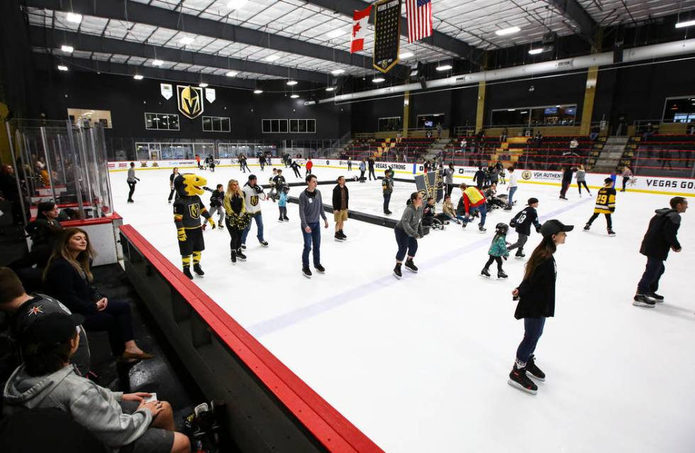 Golden Knights fans skate on the ice at City National Arena during a watch party for an away ga ...