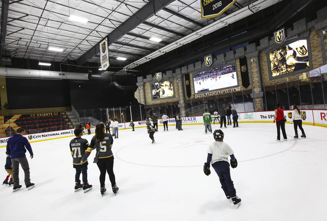 Golden Knights fans skate on the ice at City National Arena during a watch party for an away ga ...