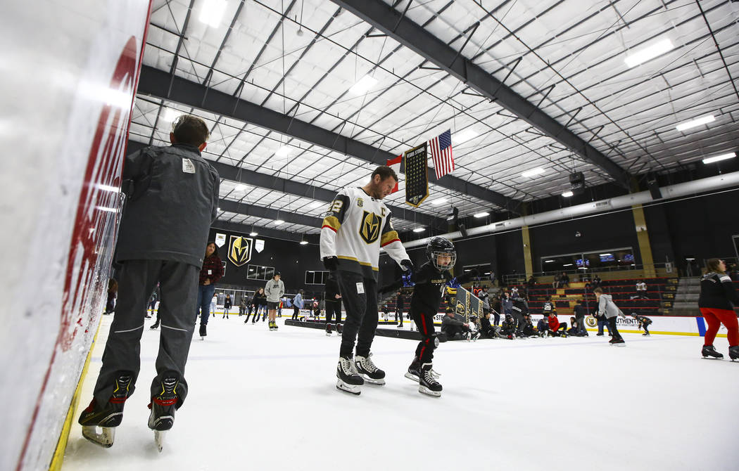 Golden Knights fans skate on the ice at City National Arena during a watch party for an away ga ...