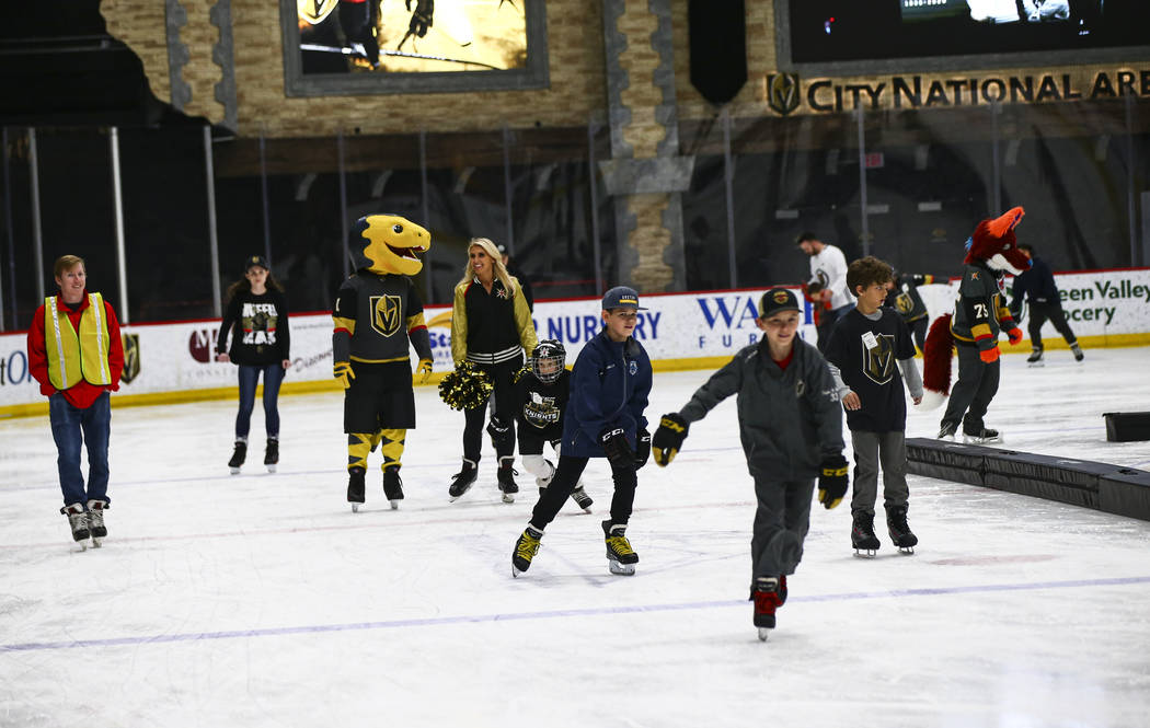 Golden Knights fans skate on the ice at City National Arena during a watch party for an away ga ...