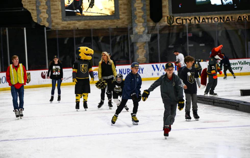 Golden Knights fans skate on the ice at City National Arena during a watch party for an away ga ...