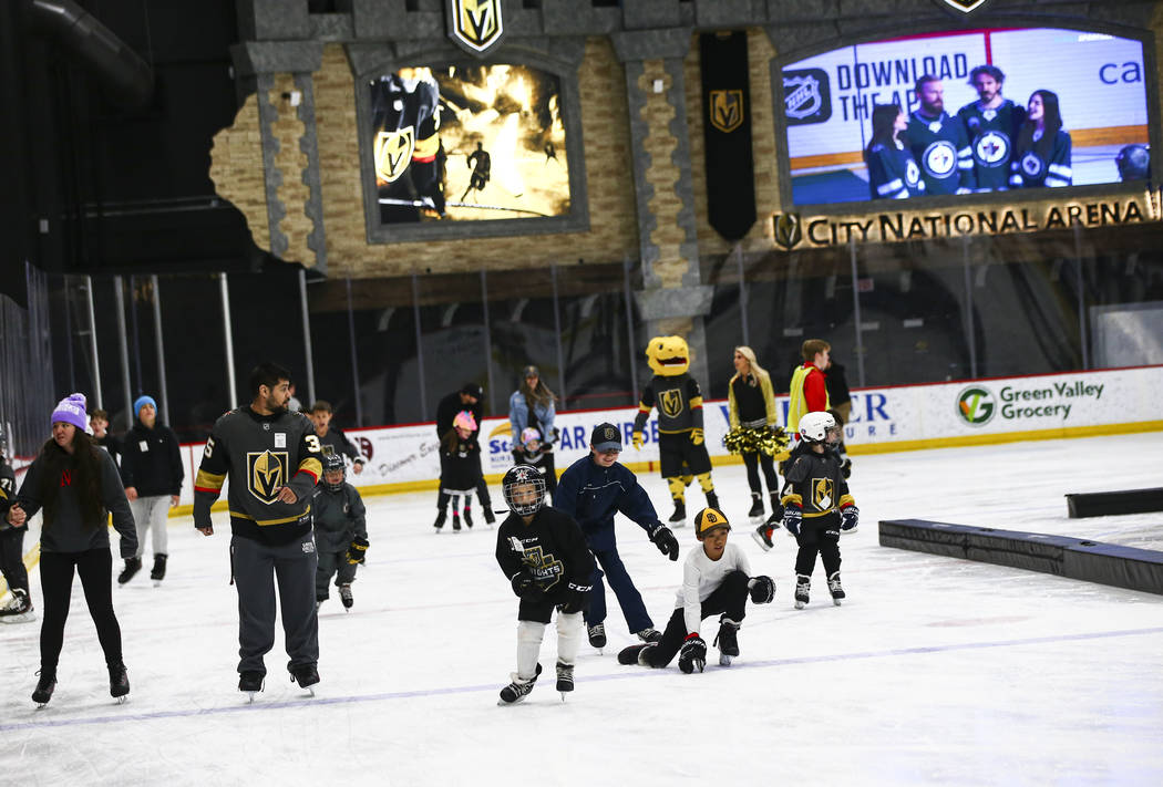 Golden Knights fans skate on the ice at City National Arena during a watch party for an away ga ...