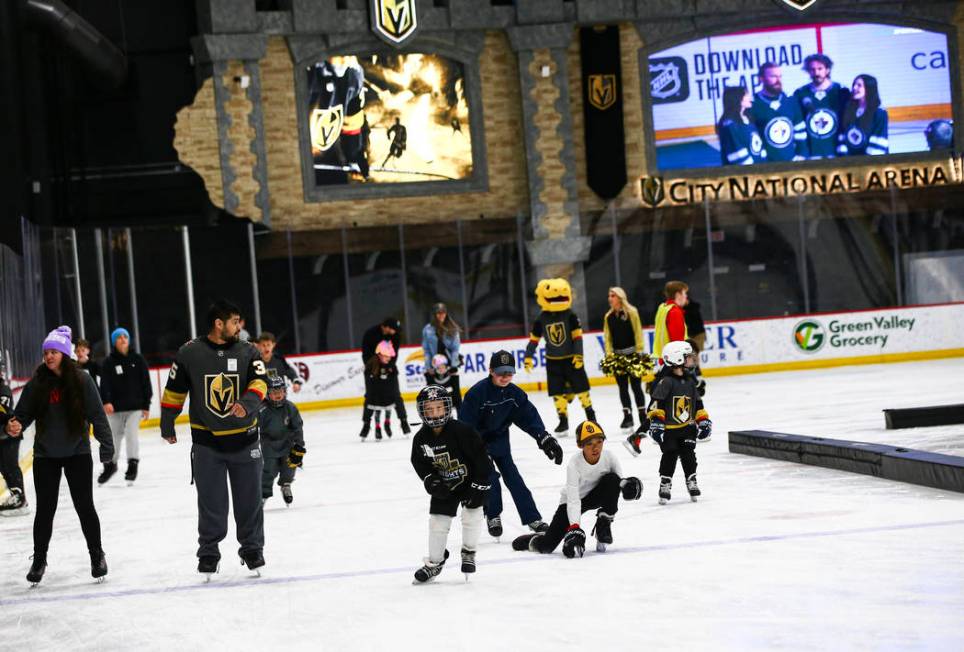 Golden Knights fans skate on the ice at City National Arena during a watch party for an away ga ...