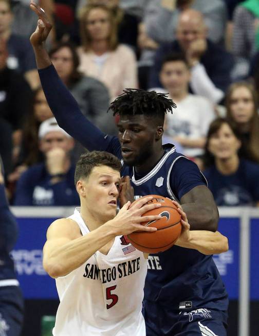 San Diego State's Yanni Wetzell (5) drives as Utah State's Neemias Queta (23) defends during th ...