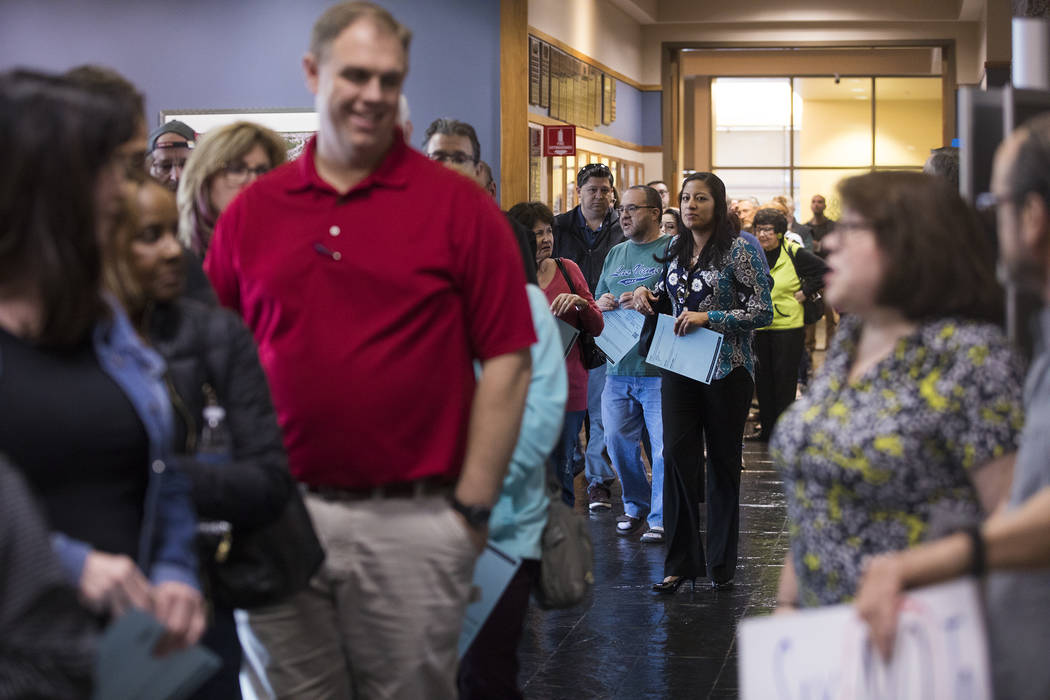 Residents wait in a long line for the second of three open house style meetings the city hosted ...