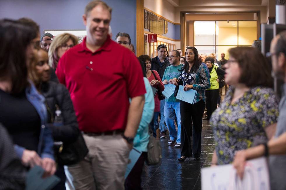 Residents wait in a long line for the second of three open house style meetings the city hosted ...