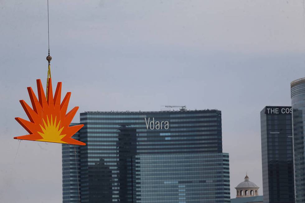 The sun in the Raiders Allegiant Stadium logo is hoisted into place, in Las Vegas, Saturday, Ma ...