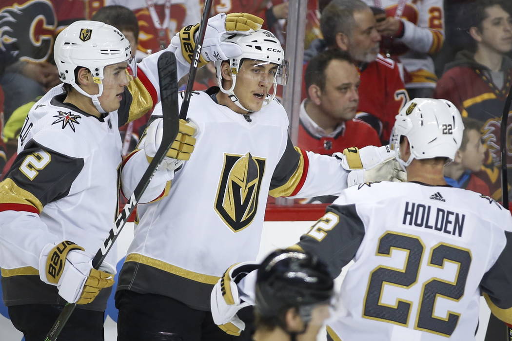 Vegas Golden Knights' Tomas Nosek, center, celebrates his goal with teammates Zach Whitecloud, ...