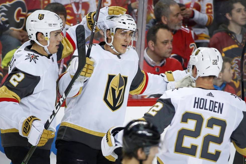 Vegas Golden Knights' Tomas Nosek, center, celebrates his goal with teammates Zach Whitecloud, ...