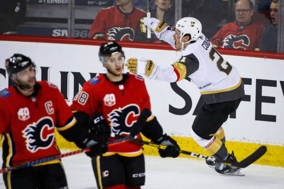 Vegas Golden Knights' Nick Cousins, right, celebrates a goal as Calgary Flames' Mark Giordano, ...