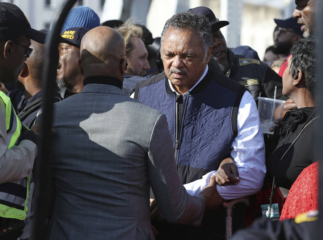 The Rev. Jesse Jackson is helped across the Edmund Pettus Bridge, Sunday, March 1, 2020, in Sel ...