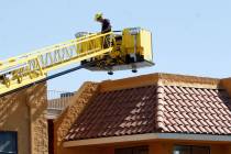 A firefighter investigates the building at 5333 S. Arville Street in Las Vegas, Sunday, March 8 ...