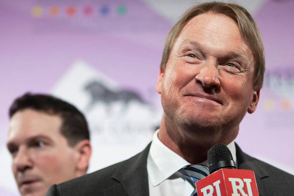 Raiders head coach John Gruden, right, talks with the media on the red carpet during the 24th A ...