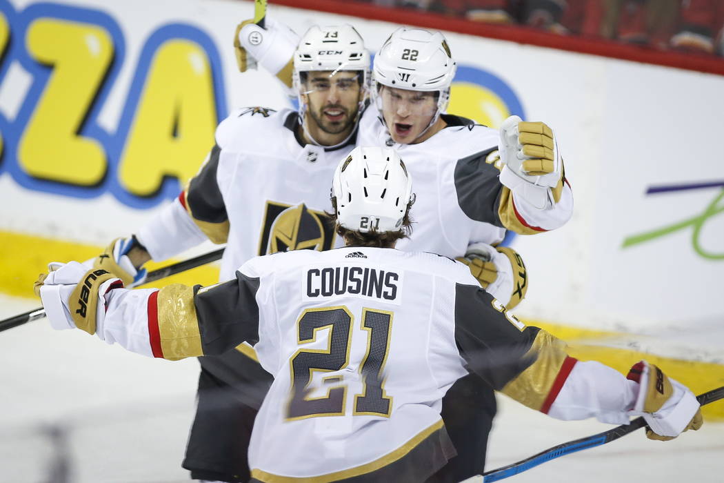 Vegas Golden Knights' Nick Holden, right, celebrates his goal with teammates Brandon Pirri, lef ...