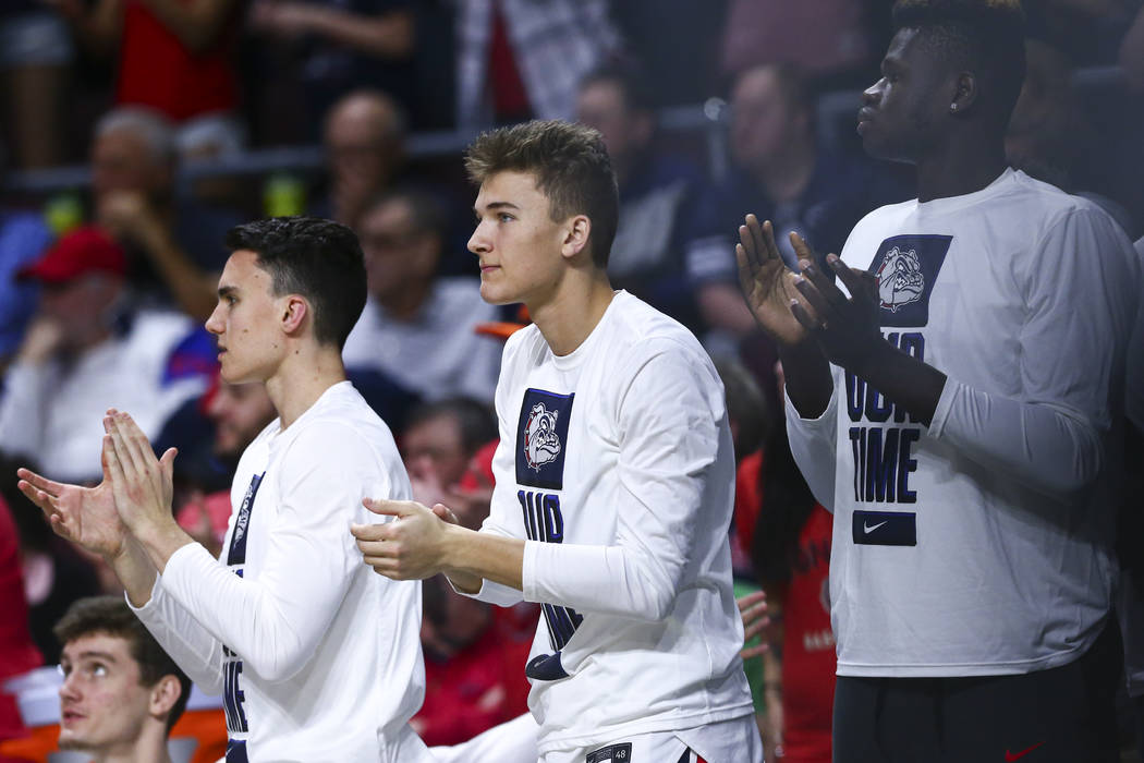 Gonzaga Bulldogs' Will Graves, center, cheers during the second half of a West Coast Conference ...
