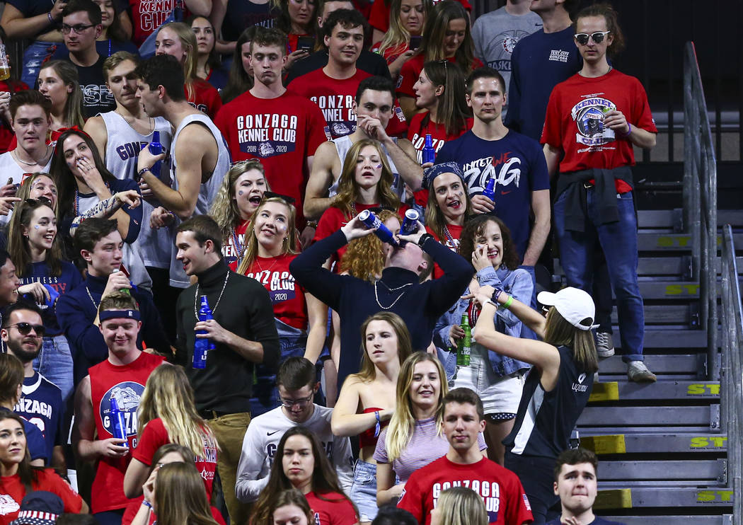 A Gonzaga Bulldogs fan downs a pair of beers during the second half of a West Coast Conference ...