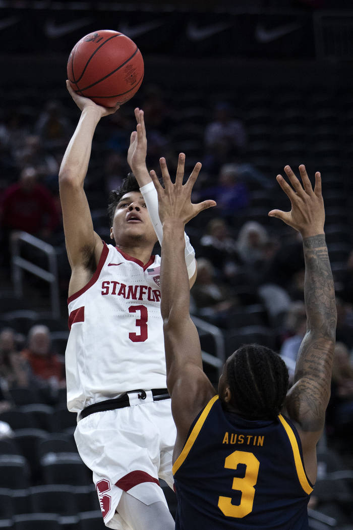 Stanford's guard Tyrell Terry (3) shoots a point as California's guard Paris Austin (3) jumps t ...