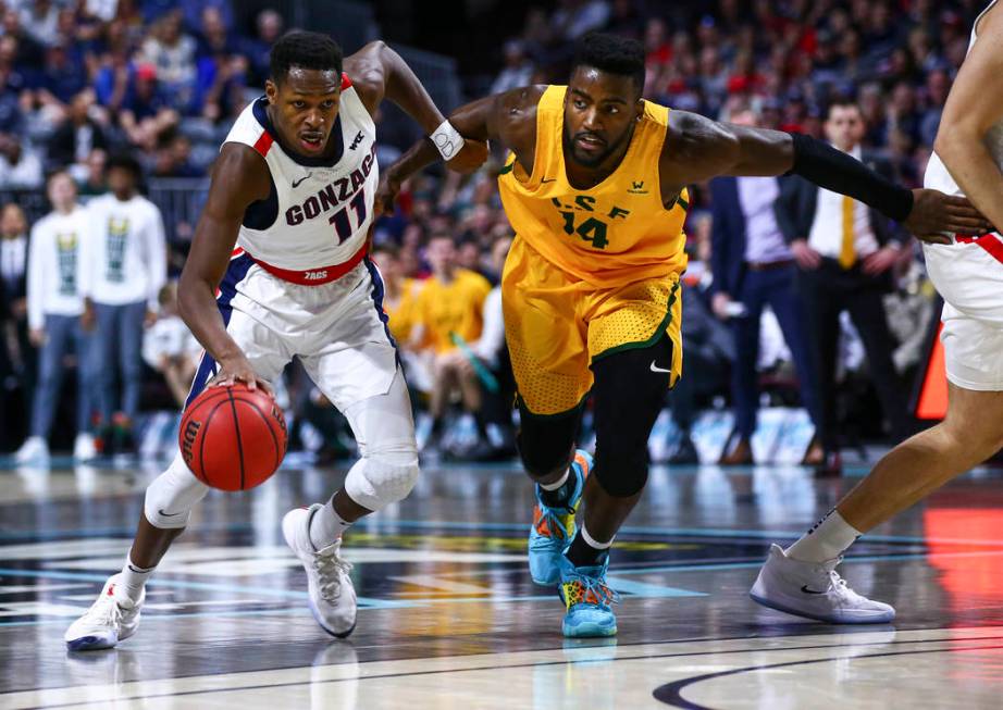 Gonzaga Bulldogs' Joel Ayayi (11) drives to the basket against San Francisco Dons' Charles Minl ...