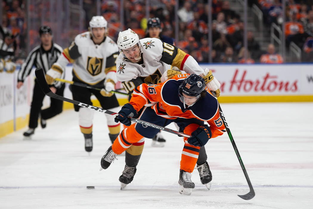 Edmonton Oilers' Kailer Yamamoto (56) is hassled by Vegas Golden Knights' Nicolas Roy (10) duri ...