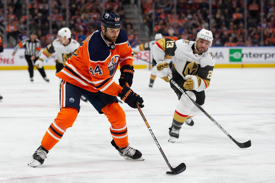Edmonton Oilers' Zack Kassian (44) is watched by Vegas Golden Knights' Alec Martinez (23) durin ...