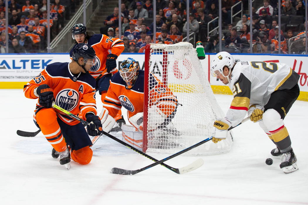 Edmonton Oilers' Darnell Nurse (25) and goaltender Mikko Koskinen (19) protect the net against ...