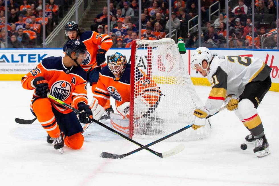 Edmonton Oilers' Darnell Nurse (25) and goaltender Mikko Koskinen (19) protect the net against ...