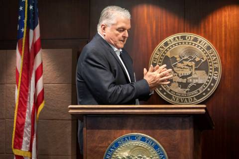 Gov. Steve Sisolak uses hand sanitizer before taking the podium to update the public about COVI ...