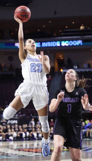 San Diego Toreros Jordyn Edwards (23) attempts a basket past Portland Pilots Kate Andersen (1) ...