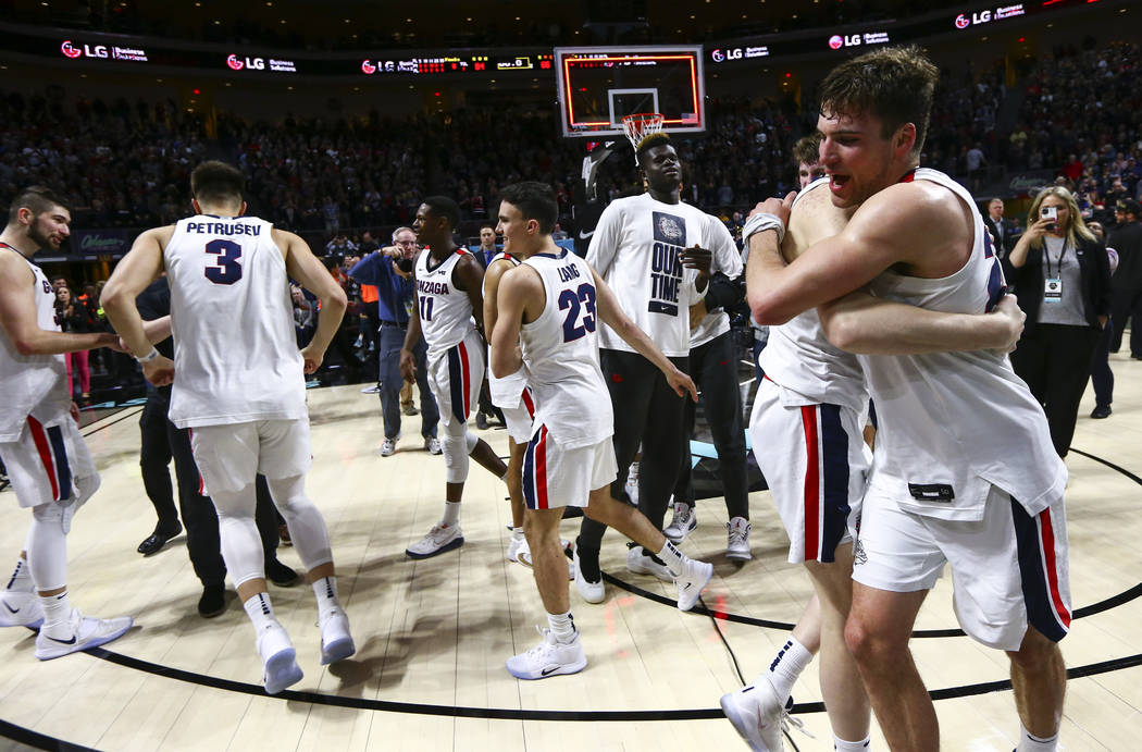 Gonzaga players celebrate after defeating St. Mary's to win the West Coast Conference tournamen ...