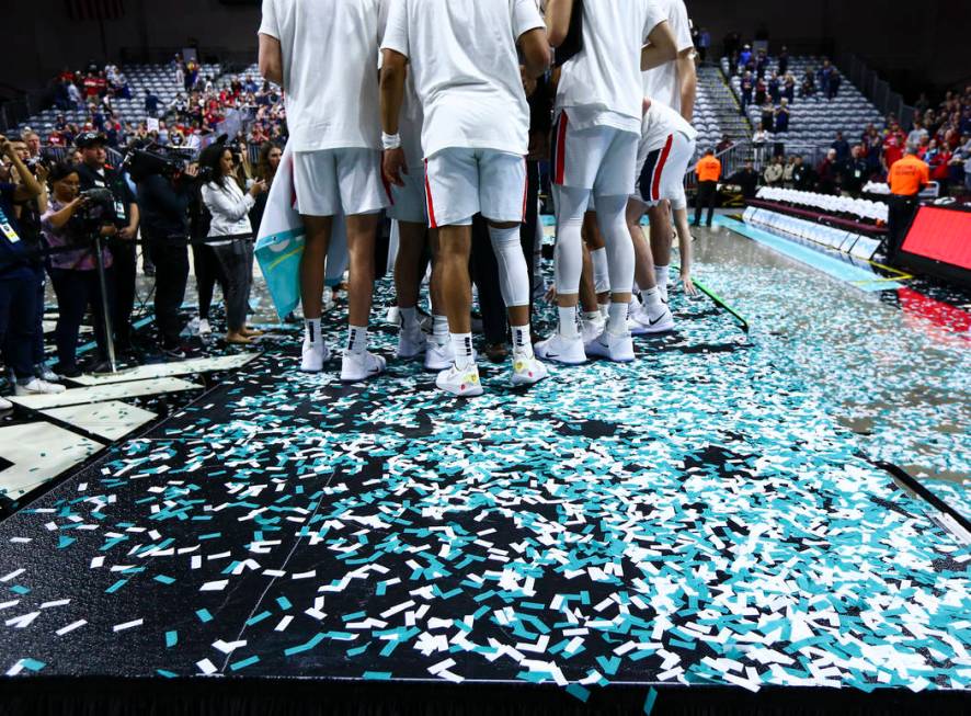 Gonzaga players celebrate after defeating St. Mary's to win the West Coast Conference tournamen ...