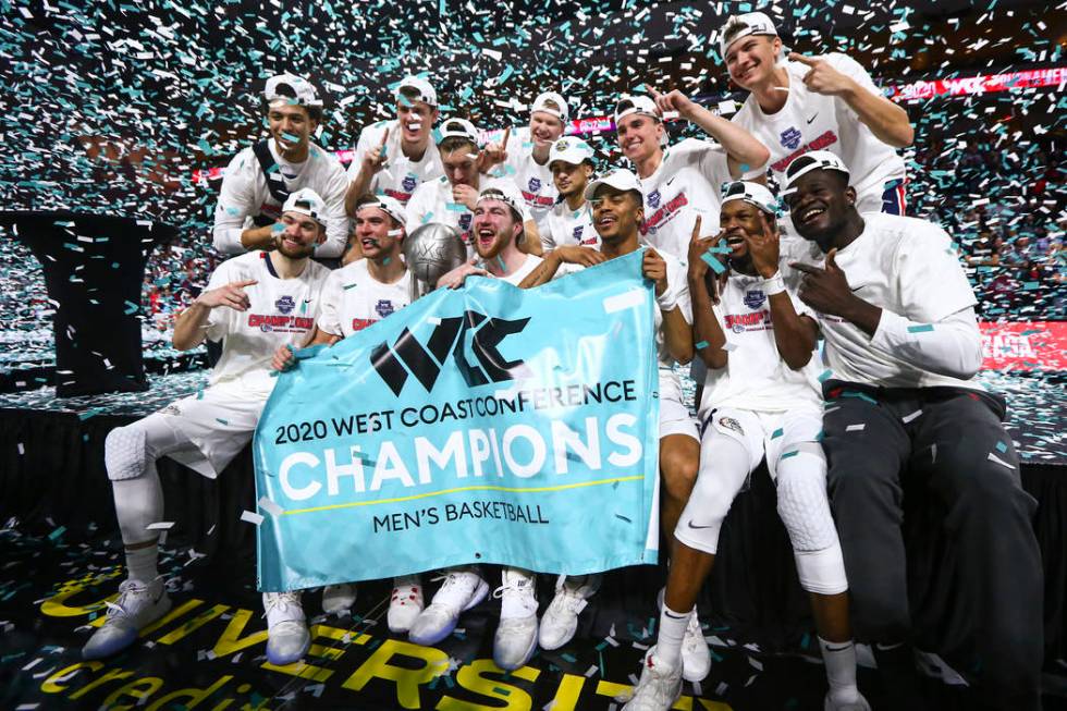 Gonzaga players celebrate after defeating St. Mary's to win the West Coast Conference tournamen ...