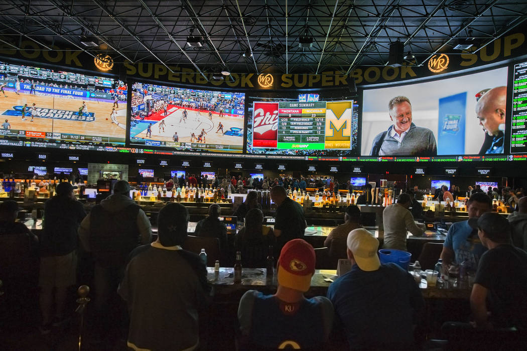 Basketball fans take in the first day of the NCAA Tournament at the Westgate Sportsbook on Thur ...