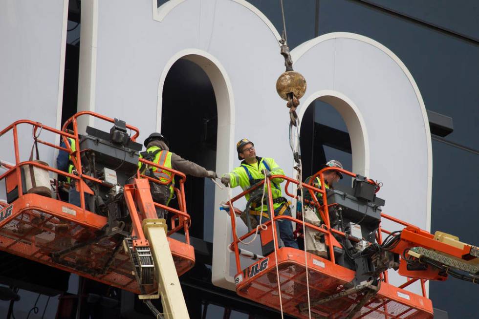 The last letter in the signage for the Raiders Allegiant Stadium logo is installed, in Las Vega ...