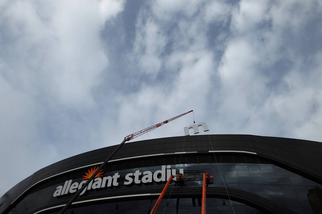 The last letter in the signage for the Raiders Allegiant Stadium logo is installed, in Las Vega ...