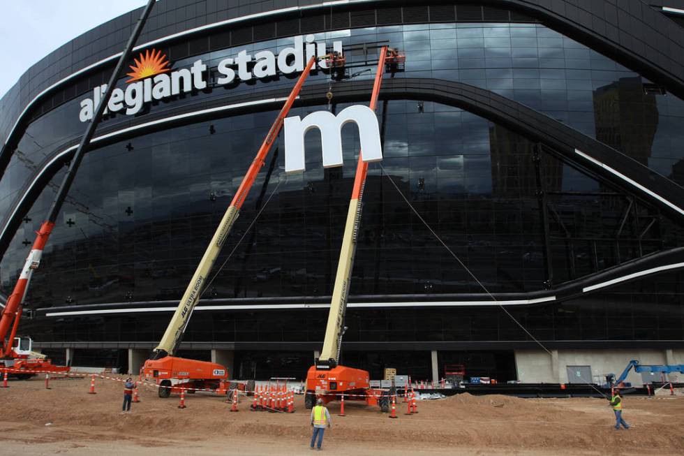 The last letter in the signage for the Raiders Allegiant Stadium logo is installed, in Las Vega ...