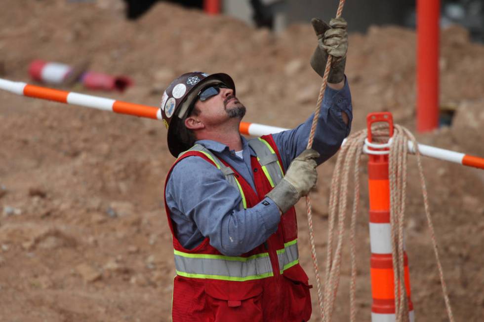 A worker helps in the installation of the last letter in the signage for the Raiders Allegiant ...