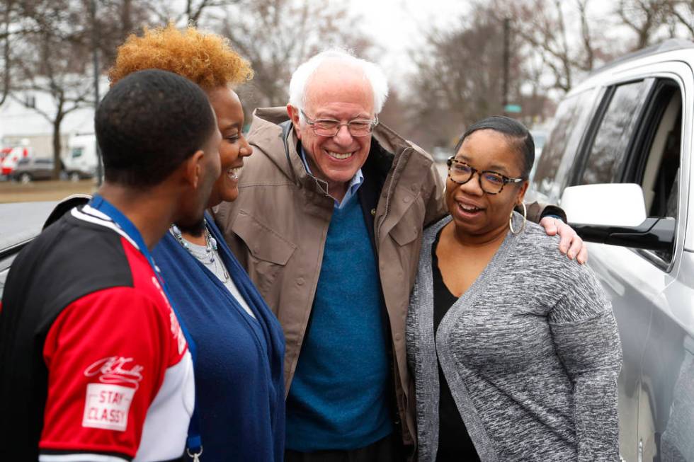 Democratic presidential candidate Sen. Bernie Sanders, I-Vt., visits custodian Davonta Bynes, f ...