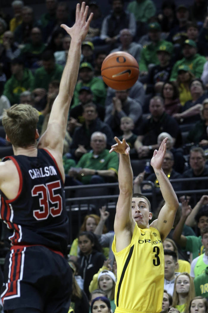 In this Feb. 16, 2020, file photo, Oregon's Payton Pritchard, right, shoots a 3-pointer over Ut ...