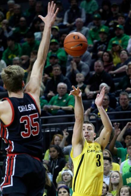 In this Feb. 16, 2020, file photo, Oregon's Payton Pritchard, right, shoots a 3-pointer over Ut ...