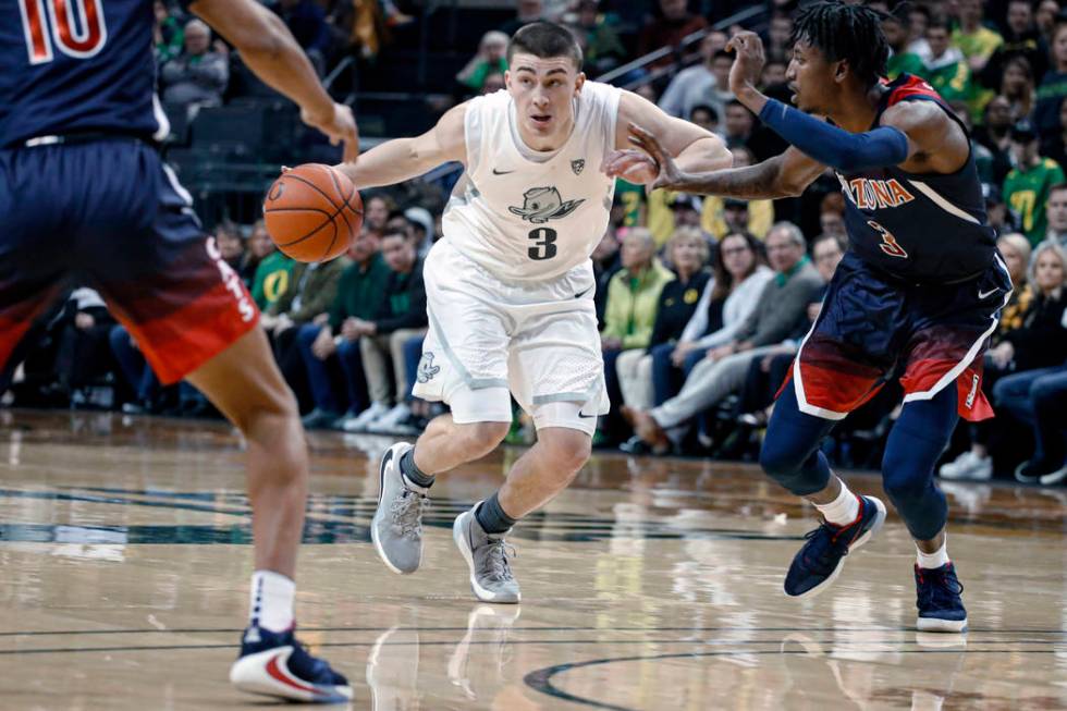 In this Jan. 9, 2020, file photo, Oregon's Payton Pritchard drives between Arizona defenders du ...