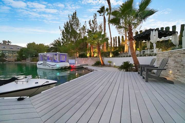 This mansion in the Lakes community at 2909 Coast Line Court comes with its own dock and boat. ...