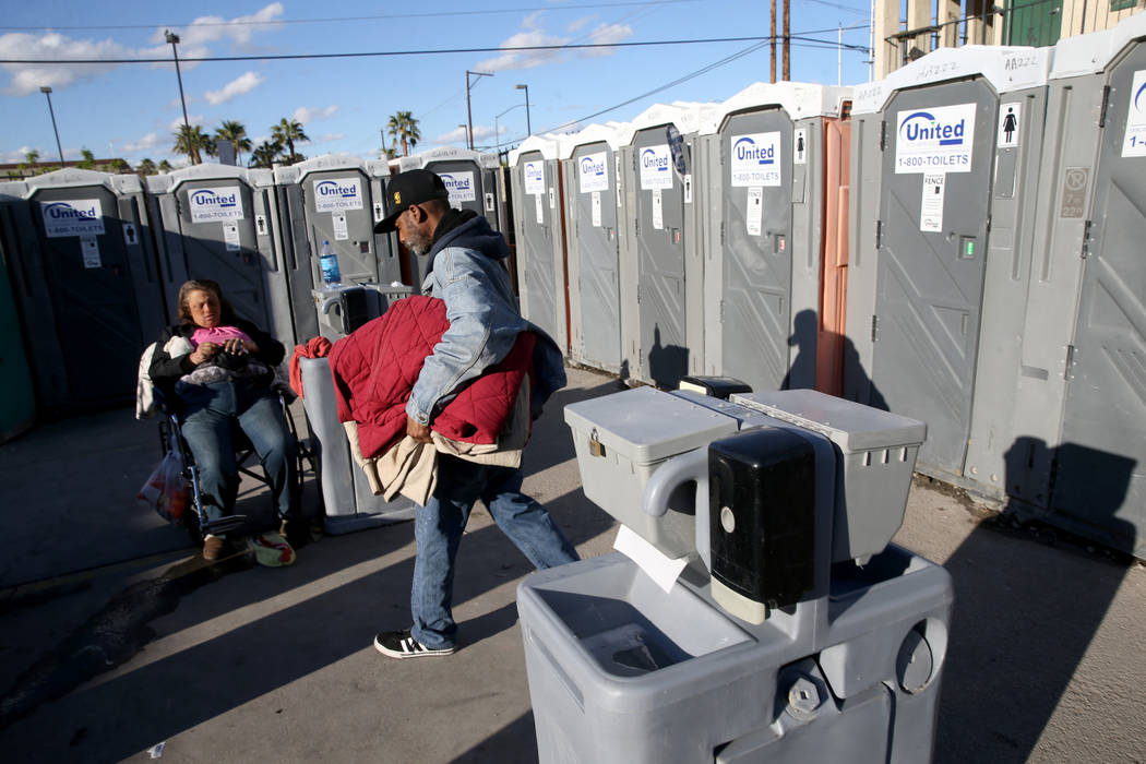 Erica "E.Z." Zehm, 42, at hand washing stations at The Courtyard Homeless Resource Ce ...