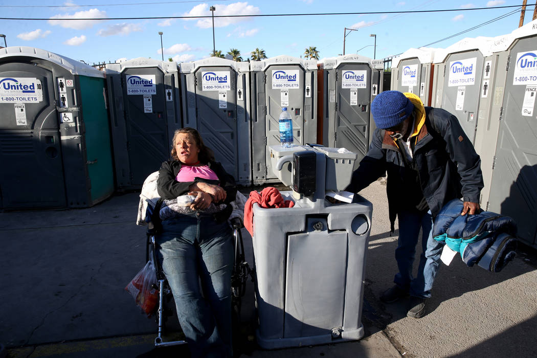 Erica "E.Z." Zehm, 42, at hand washing stations at The Courtyard Homeless Resource Ce ...