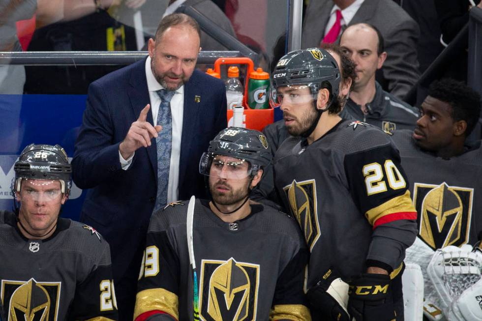 Golden Knights head coach Peter DeBoer talks with Vegas Golden Knights center Chandler Stephens ...