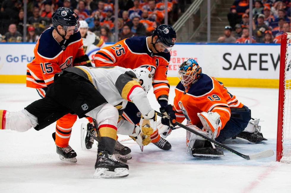 Edmonton Oilers' Darnell Nurse (25) and goaltender Mikko Koskinen (19) keep Vegas Golden Knight ...